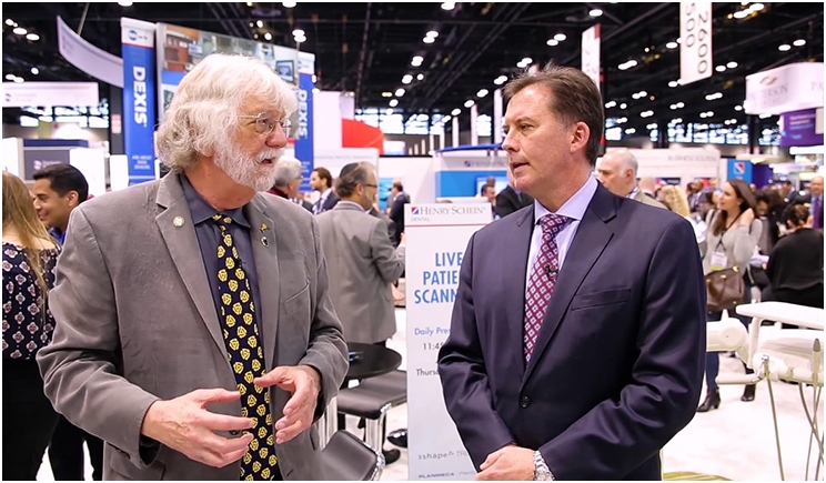 John Cox (right), vice president of Henry Schein, promotes the company's technology solutions at dental trade shows and speaks with editors such as Dentistry Today's Dr. Paul Feuerstein.