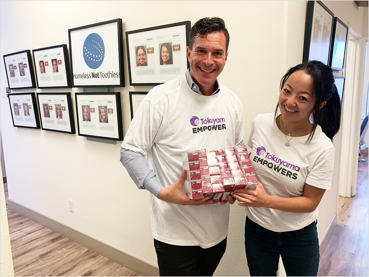 Homeless Not Toothless founder Dr. Jay Grossman received donated products from Anna Mai, associate product manager at Tokuyama Dental America.