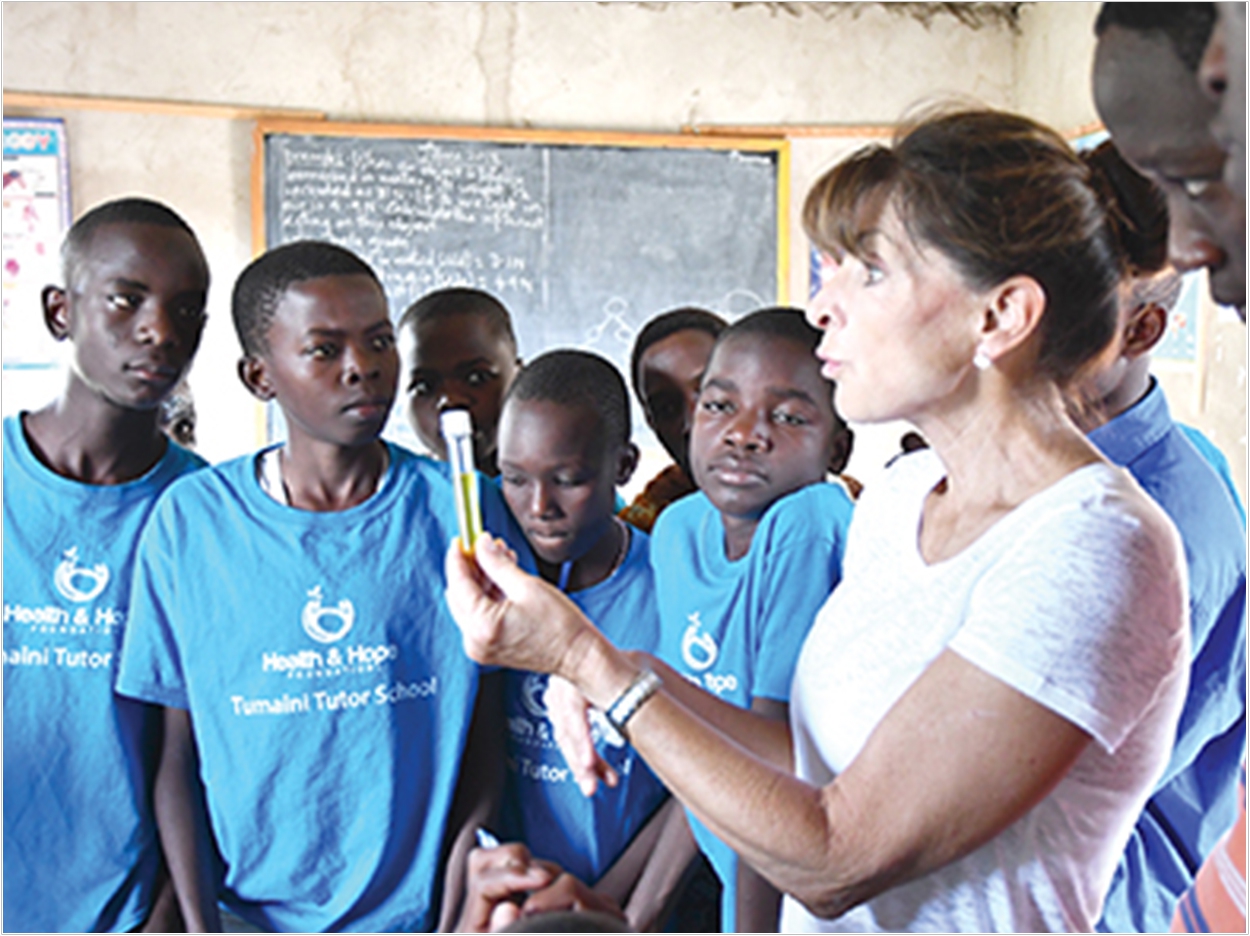 In Kangetutya Village in Tanzania in 2017, Dr. Loree Bolin teaches secondary students and teachers how to perform microbiology water testing for the safety of the local boreholes and other water sources.