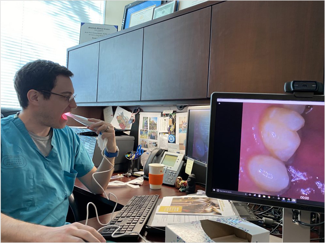 Dr. Howell showing friends and colleagues how he uses the intraoral camera.